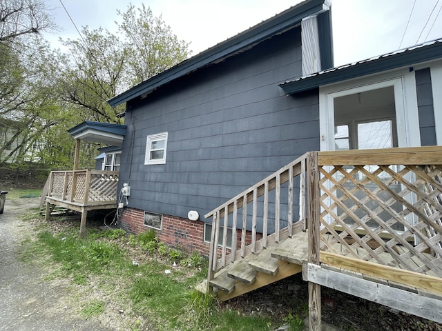 view of home's exterior with a wooden deck