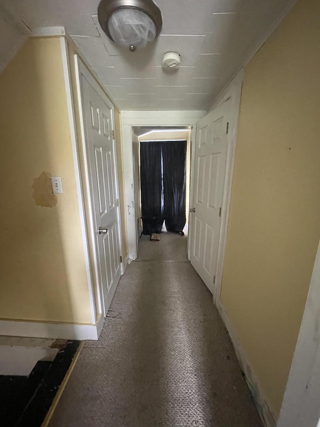 hallway featuring baseboards