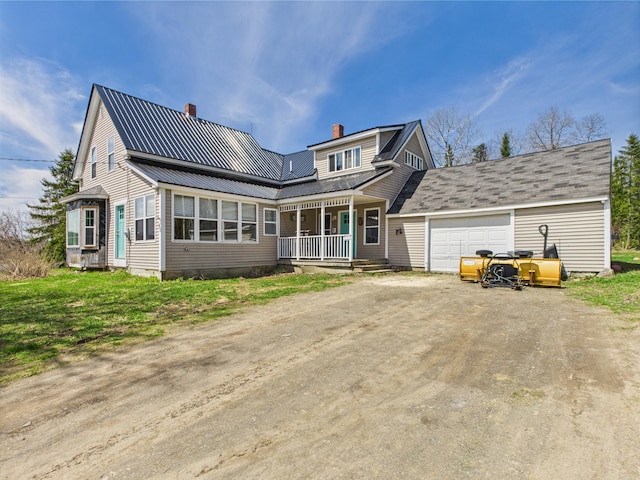 60 Carson Rd, Perham, ME 04766 - view of front of house with an attached garage, a chimney, dirt driveway, metal roof, and a porch