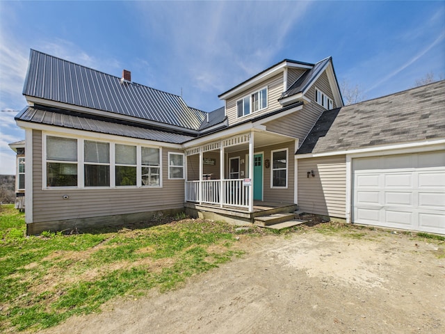 60 Carson Rd, Perham, ME 04766 - view of front of property featuring covered porch, dirt driveway, an attached garage, and metal roof