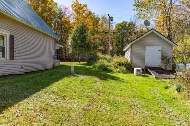753 Sebec Village Rd, Sebec, ME 04481 - view of grassy yard featuring an outdoor structure and a shed