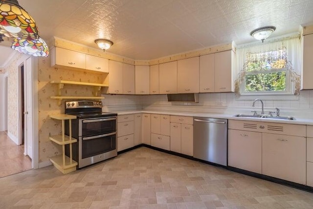 753 Sebec Village Rd, Sebec, ME 04481 - kitchen with stainless steel appliances, open shelves, light countertops, a sink, and decorative backsplash