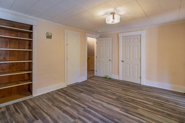 753 Sebec Village Rd, Sebec, ME 04481 - unfurnished bedroom with baseboards, dark wood finished floors, and ornamental molding