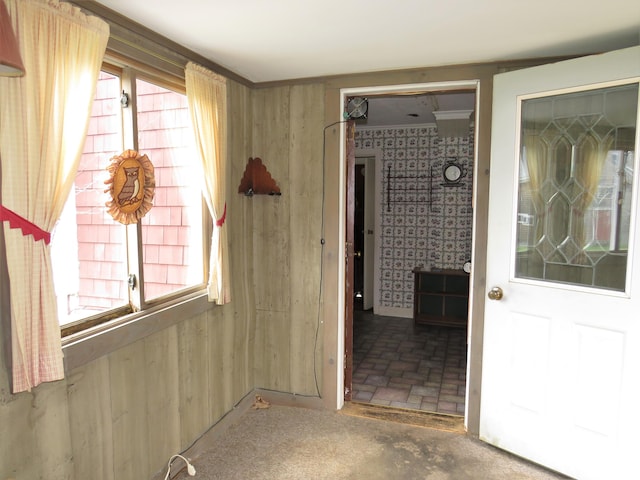 interior space with brick floor and wallpapered walls