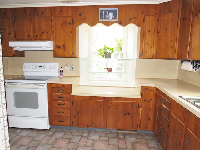 kitchen with extractor fan, white range with electric stovetop, light countertops, and brown cabinets