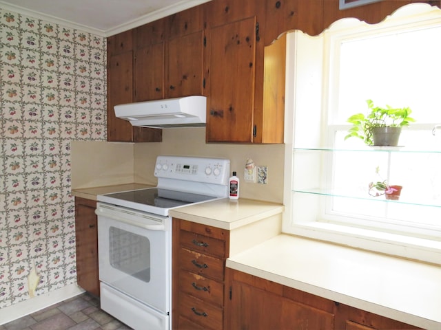 kitchen with ventilation hood, wallpapered walls, brown cabinets, and electric stove