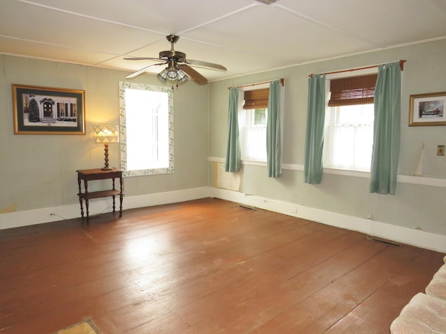 unfurnished room with visible vents, ceiling fan, and hardwood / wood-style flooring