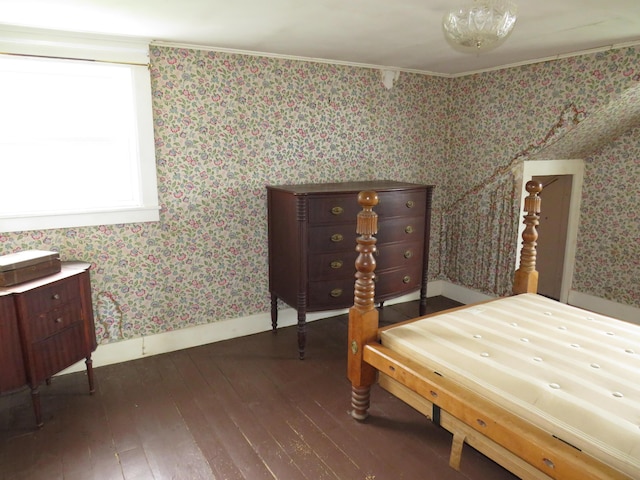 bedroom with wallpapered walls, dark wood-style flooring, and baseboards