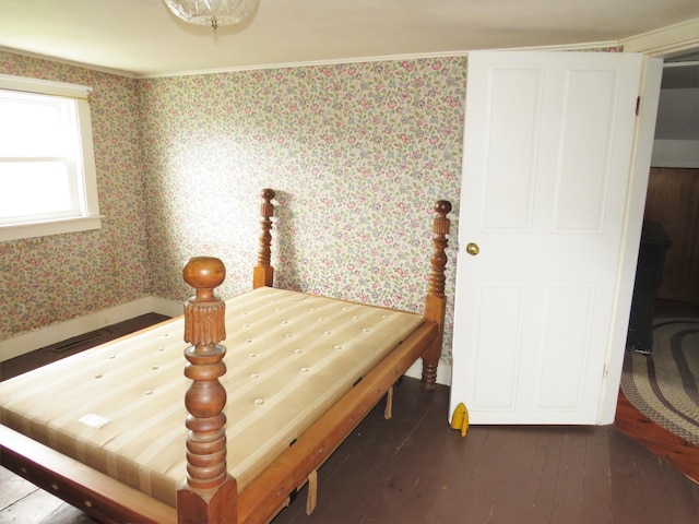 bedroom with wallpapered walls, baseboards, and hardwood / wood-style floors