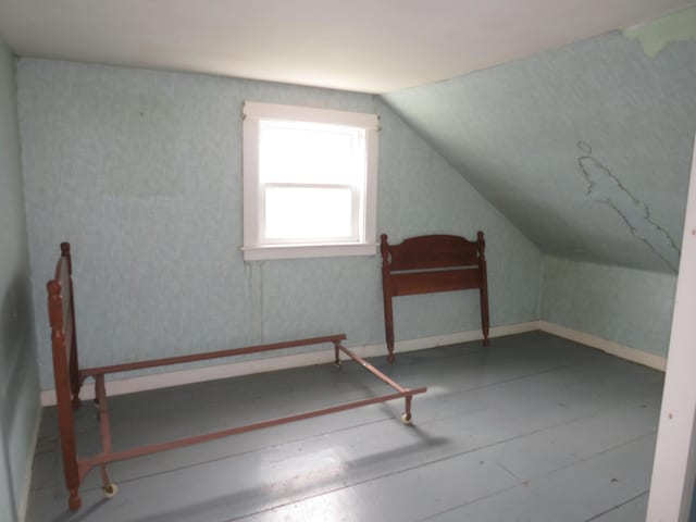 additional living space featuring vaulted ceiling