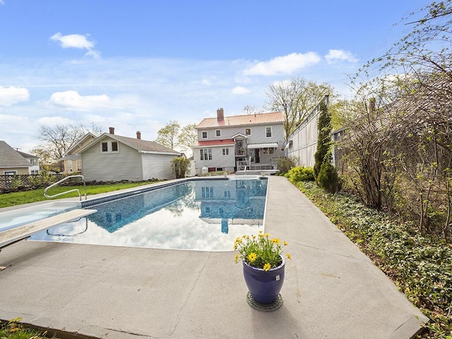 view of pool with a patio, a diving board, and an outdoor structure