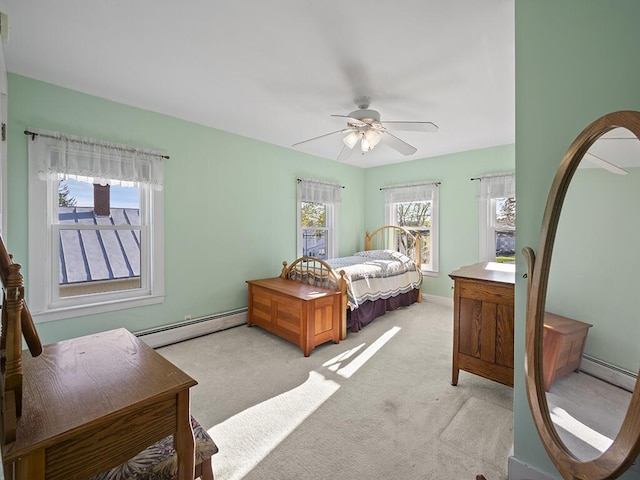 bedroom featuring a baseboard radiator, light colored carpet, ceiling fan, and baseboards