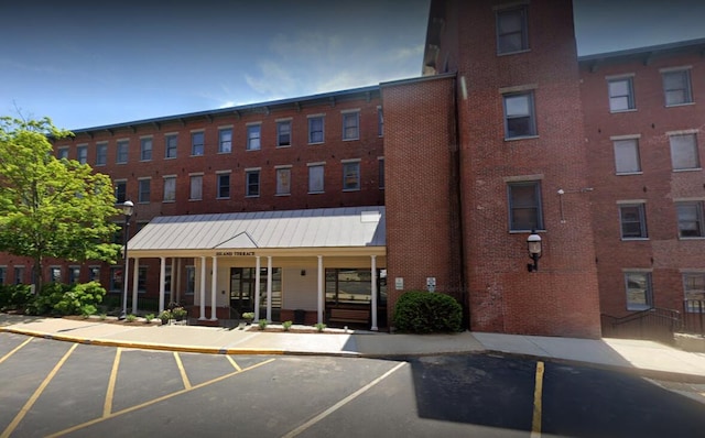 view of building exterior with uncovered parking
