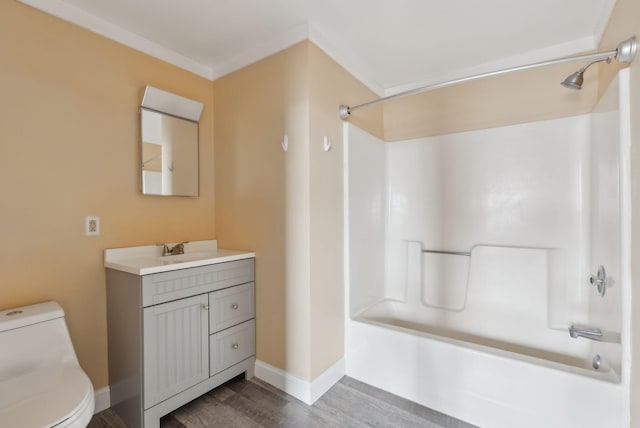 full bath with  shower combination, toilet, wood finished floors, vanity, and baseboards
