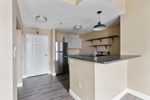kitchen with stainless steel appliances, open shelves, a peninsula, dark wood-type flooring, and baseboards