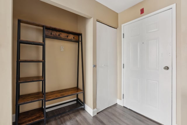 entryway with dark wood finished floors and baseboards