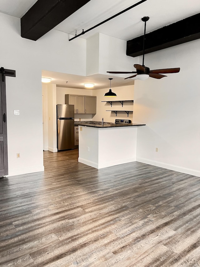 1 Saco Island Ter Unit 205, Saco, ME 04072 - kitchen featuring freestanding refrigerator, dark countertops, a barn door, ceiling fan, and gray cabinetry