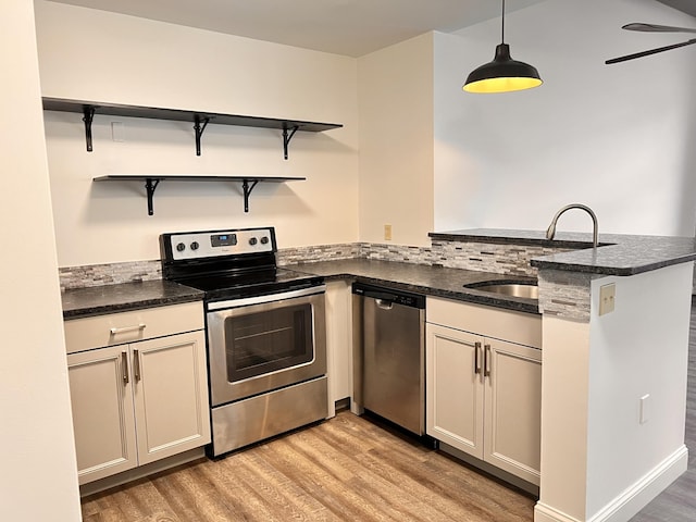 1 Saco Island Ter Unit 205, Saco, ME 04072 - kitchen featuring stainless steel appliances, a sink, a peninsula, light wood-style flooring, and open shelves