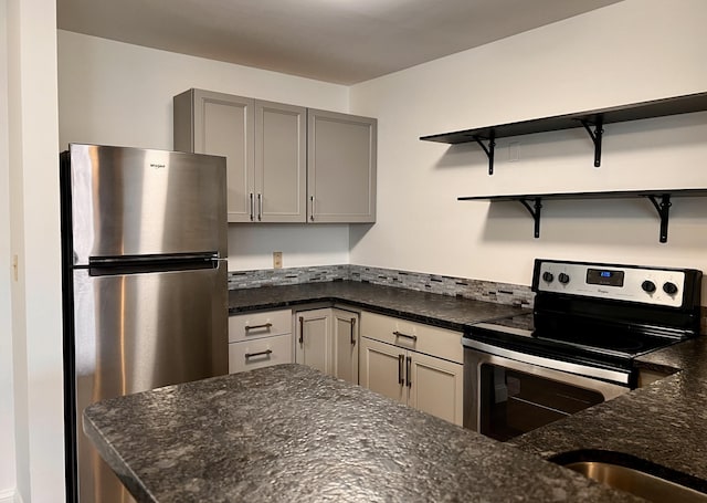 1 Saco Island Ter Unit 205, Saco, ME 04072 - kitchen with appliances with stainless steel finishes, open shelves, dark stone countertops, and gray cabinets