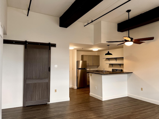 1 Saco Island Ter Unit 205, Saco, ME 04072 - kitchen featuring freestanding refrigerator, dark countertops, ceiling fan, a peninsula, and a barn door