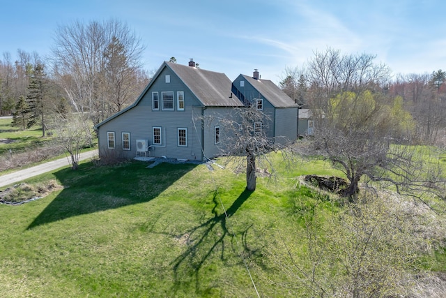 view of property exterior featuring a yard and a chimney