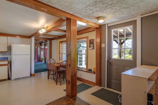 doorway with a wealth of natural light and baseboards