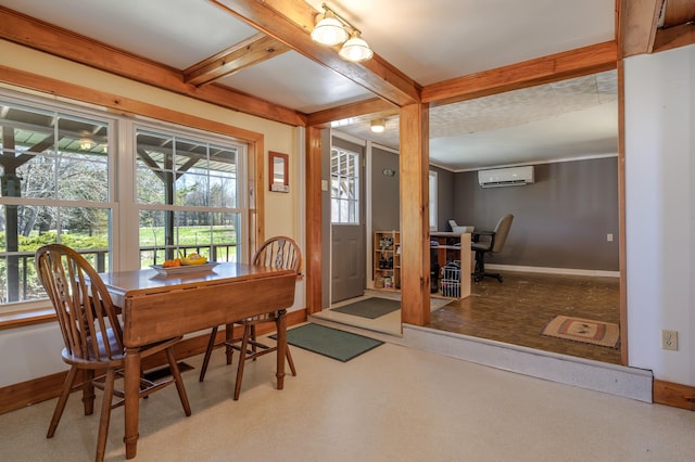 dining space featuring baseboards, beamed ceiling, a healthy amount of sunlight, and an AC wall unit