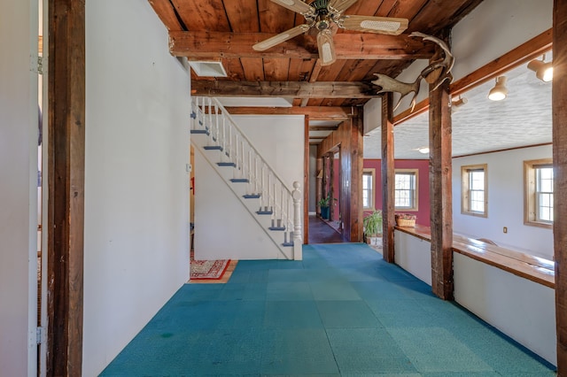 hallway featuring wood ceiling, beamed ceiling, and stairs