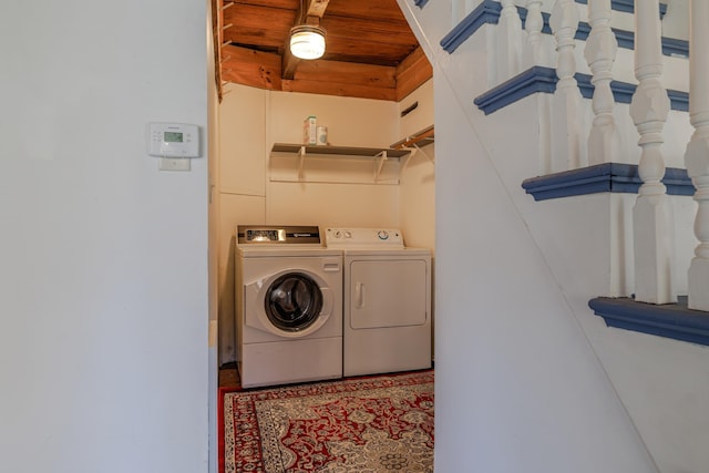 washroom featuring wooden ceiling, separate washer and dryer, and laundry area