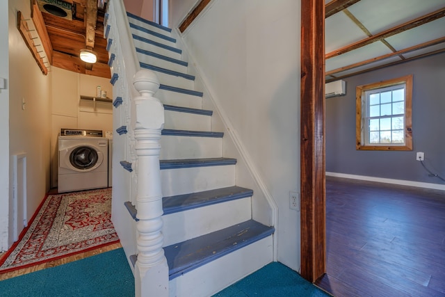 staircase featuring washer and dryer, wood finished floors, baseboards, and a wall mounted AC
