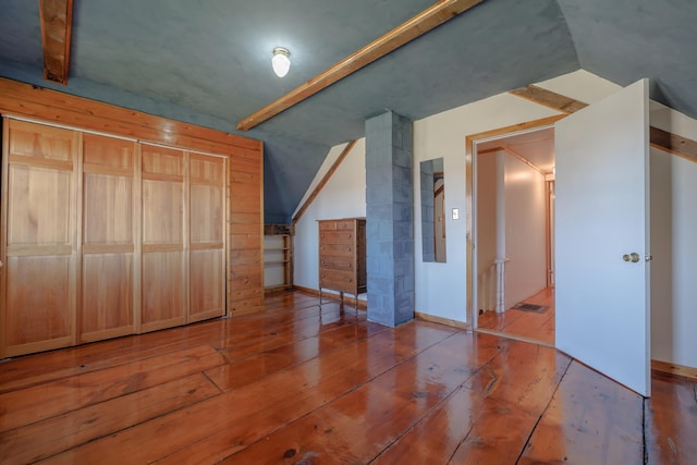 bonus room featuring vaulted ceiling and wood-type flooring