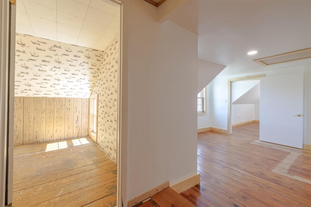 additional living space featuring wood-type flooring and baseboards