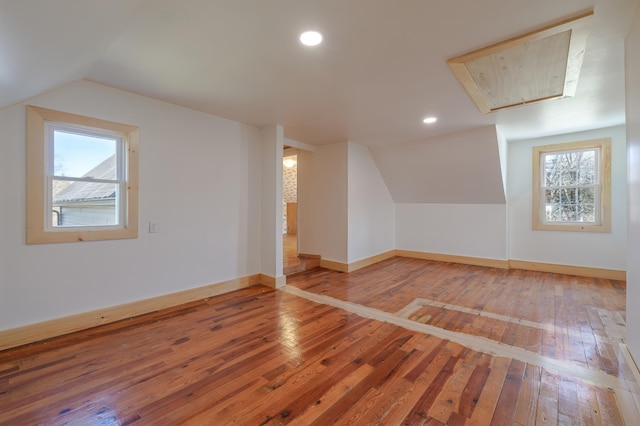bonus room featuring attic access, hardwood / wood-style floors, baseboards, vaulted ceiling, and recessed lighting