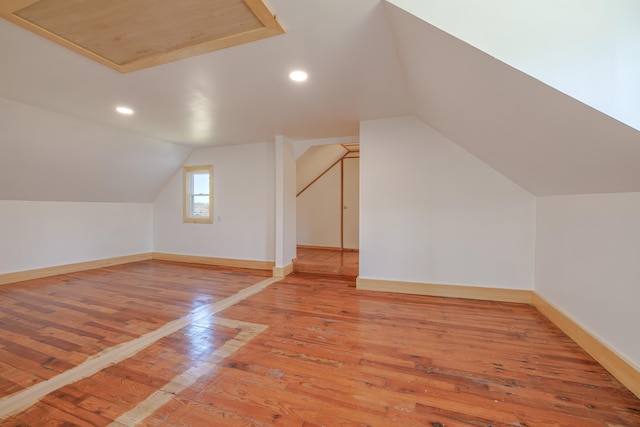 bonus room featuring lofted ceiling, light wood-style flooring, baseboards, and recessed lighting