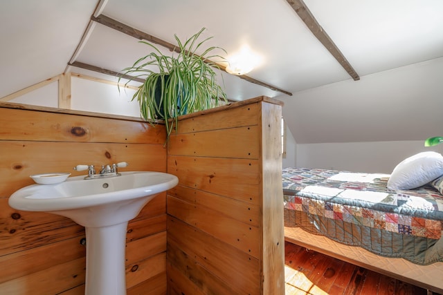 interior space with lofted ceiling, hardwood / wood-style floors, and a sink