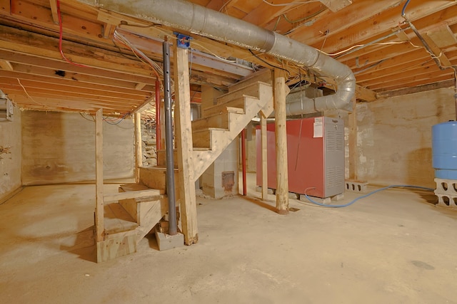 unfinished basement featuring stairs