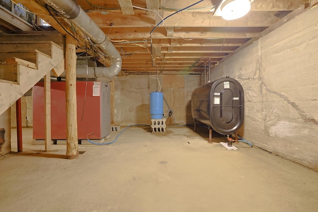 unfinished basement with heating fuel and stairs
