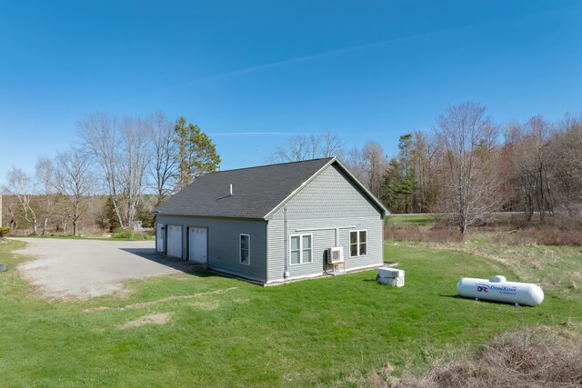 370 Christian Ridge Rd, Ellsworth, ME 04605 - rear view of house with a garage, a shingled roof, and a lawn