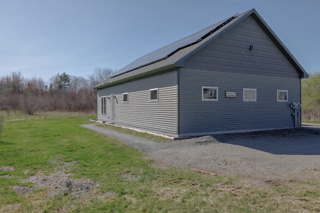 view of home's exterior featuring a yard and solar panels
