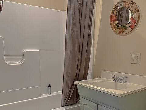 bathroom featuring vanity and shower / tub combo