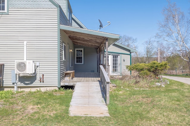 property entrance featuring a yard and ac unit
