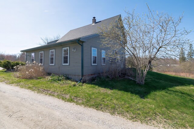 370 Christian Ridge Rd, Ellsworth, ME 04605 - view of home's exterior featuring a chimney and a yard