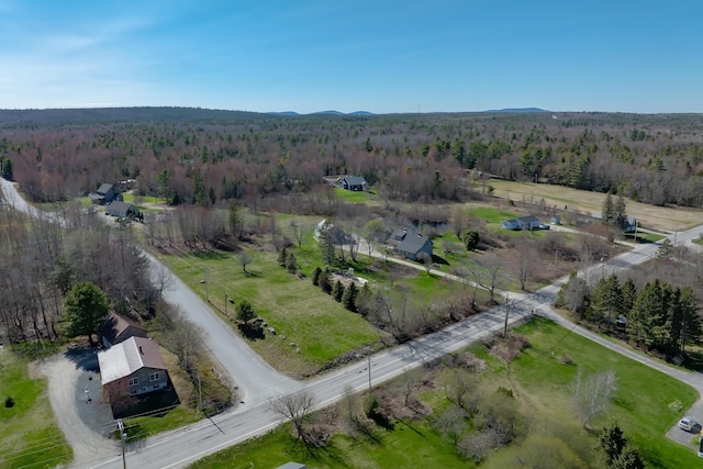 birds eye view of property featuring a forest view