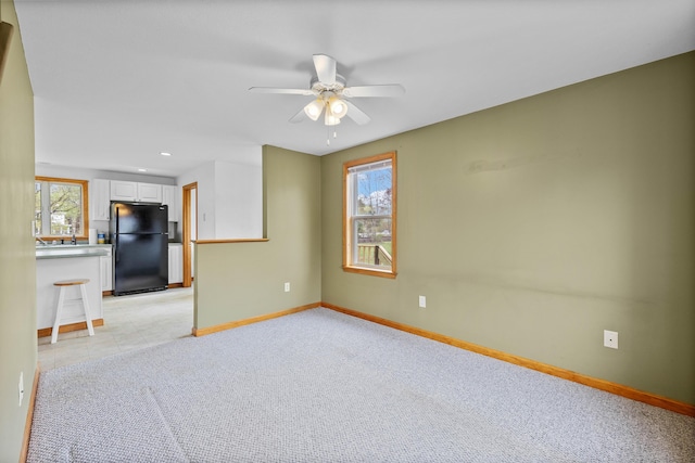 spare room with baseboards, ceiling fan, light carpet, and recessed lighting