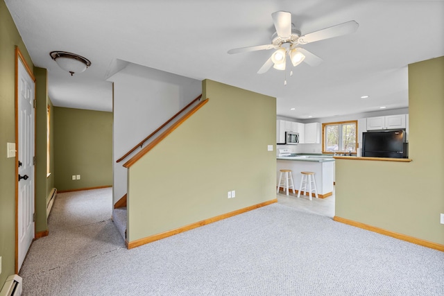 living room featuring a baseboard radiator, light carpet, a ceiling fan, stairway, and recessed lighting