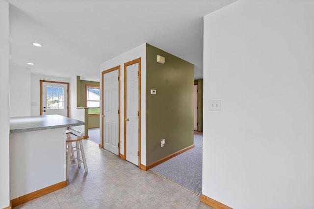 hallway with baseboards and recessed lighting