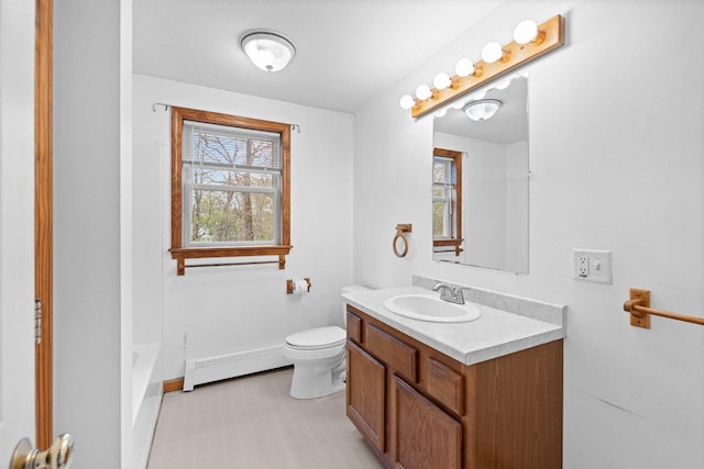 full bath with baseboard heating, plenty of natural light, toilet, and vanity