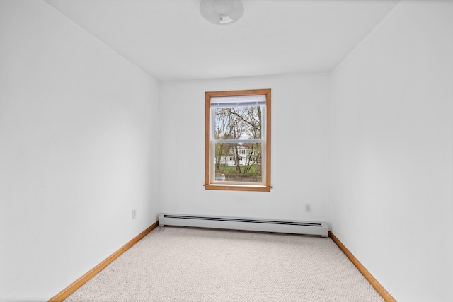unfurnished room with baseboard heating, baseboards, and carpet floors