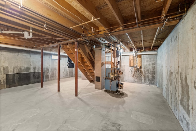 unfinished below grade area featuring stairs and heating unit