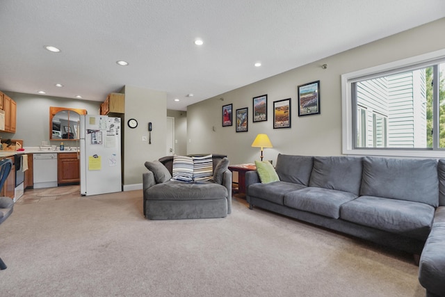 living area with light carpet and recessed lighting